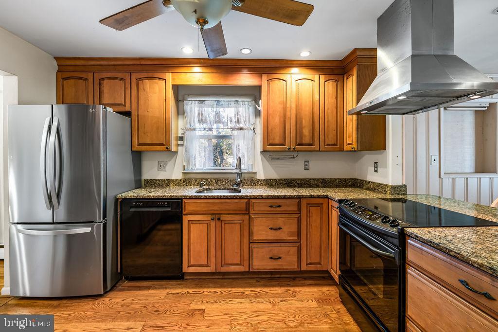 577 Brock Bridge Road Laurel, MD 20724 - Photo 4 of 41 a kitchen with stainless steel appliances granite countertop a stove a refrigerator and a sink