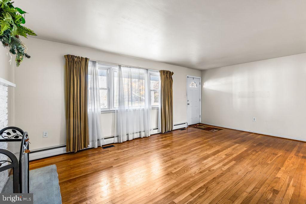 577 Brock Bridge Road Laurel, MD 20724 - Photo 7 of 41 an empty room with wooden floor and windows
