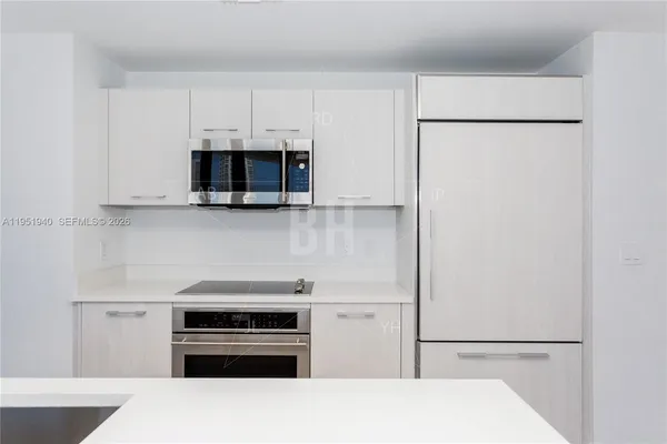 a kitchen with stainless steel appliances a stove a microwave and a refrigerator