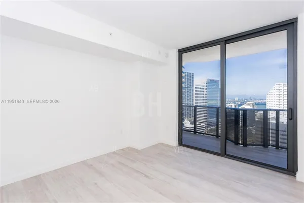 a view of an empty room with glass door
