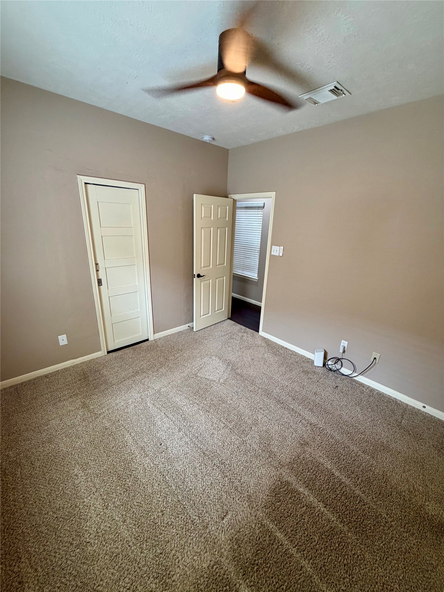 903 Cascade Ridge Katy, TX 77494 - Photo 18 of 24 a view of an empty room with a chandelier fan
