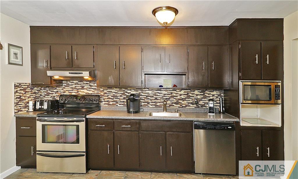 64 Valley Road Jackson, NJ 08527 - Photo 12 of 24 a kitchen with a stove and a refrigerator