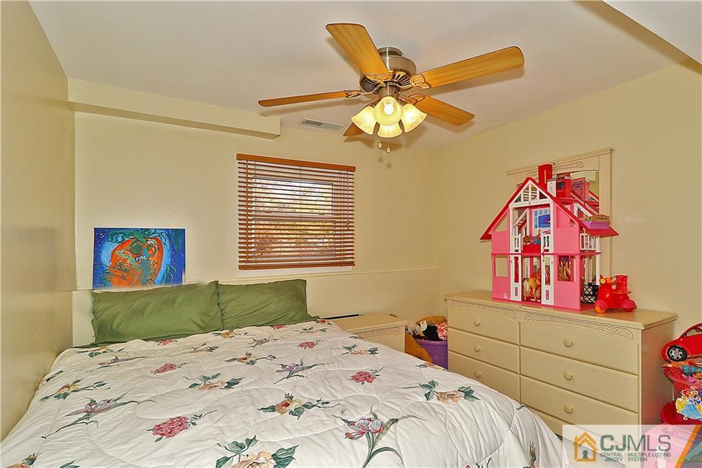 64 Valley Road Jackson, NJ 08527 - Photo 14 of 24 a bedroom with a bed and a dresser
