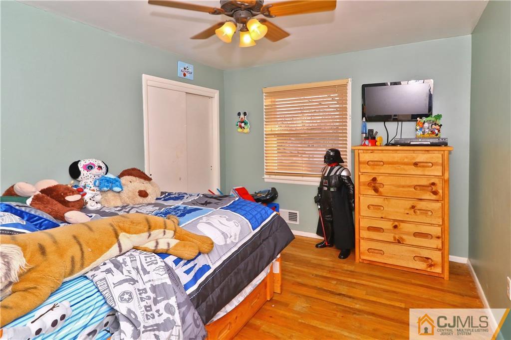 64 Valley Road Jackson, NJ 08527 - Photo 16 of 24 a bedroom with a bed and a chandelier