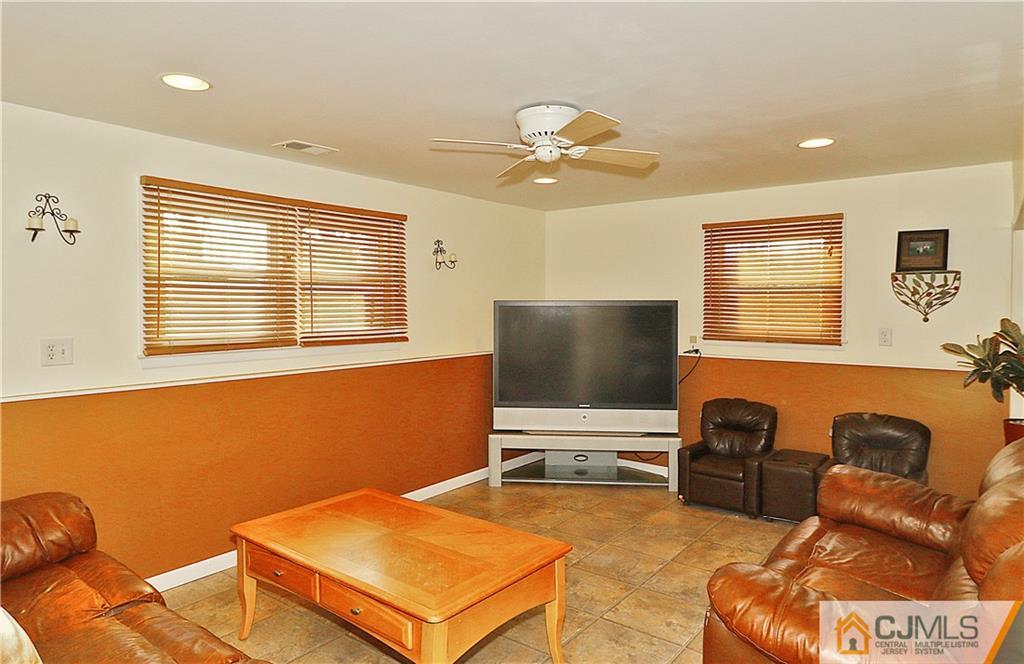 64 Valley Road Jackson, NJ 08527 - Photo 18 of 24 a living room with furniture and a flat screen tv