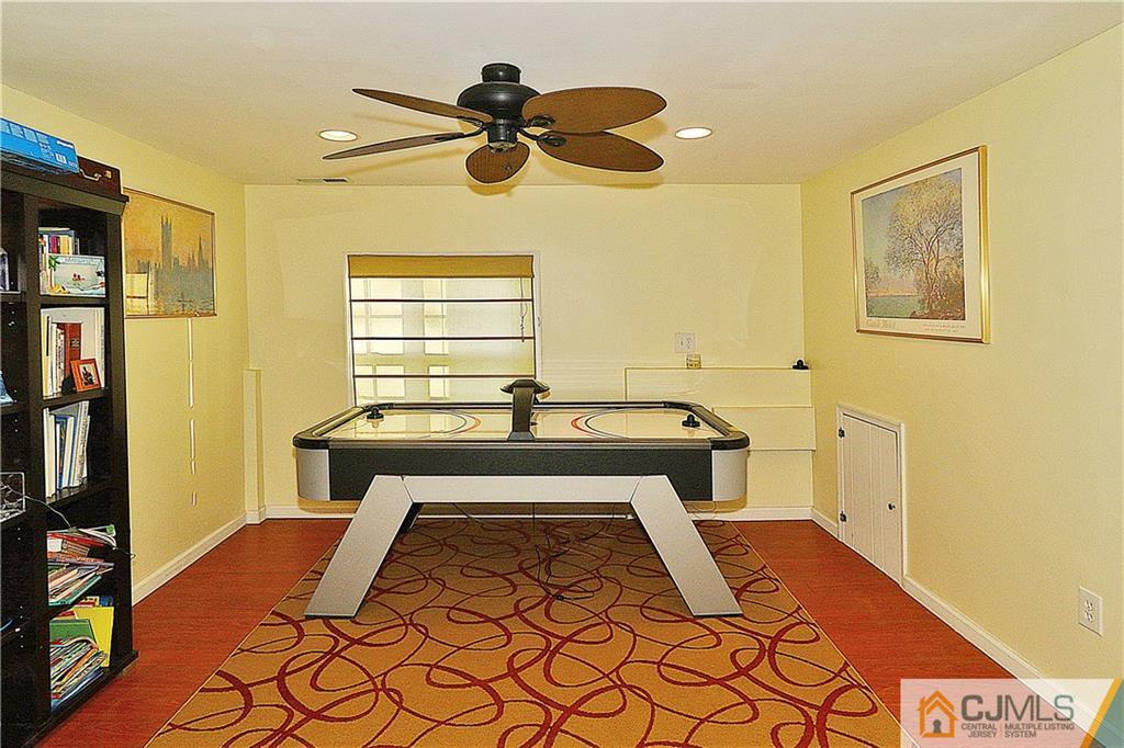 64 Valley Road Jackson, NJ 08527 - Photo 19 of 24 a bedroom with a bed and a chandelier