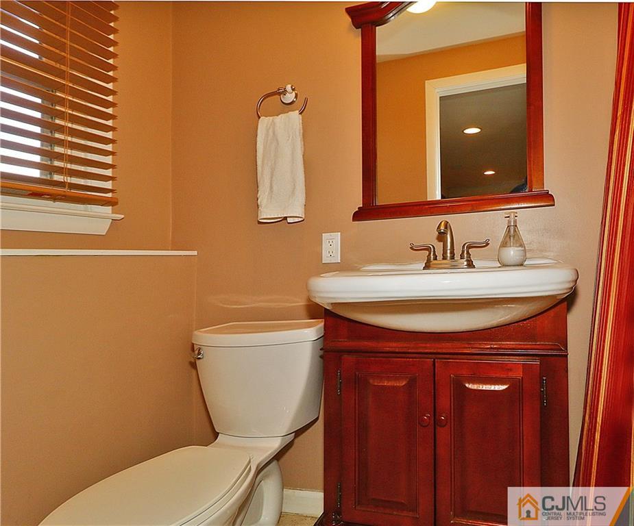 64 Valley Road Jackson, NJ 08527 - Photo 21 of 24 a bathroom with a toilet a sink and mirror