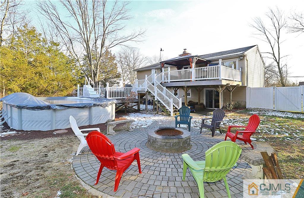 64 Valley Road Jackson, NJ 08527 - Photo 22 of 24 a backyard of a house with fire pit and outdoor seating