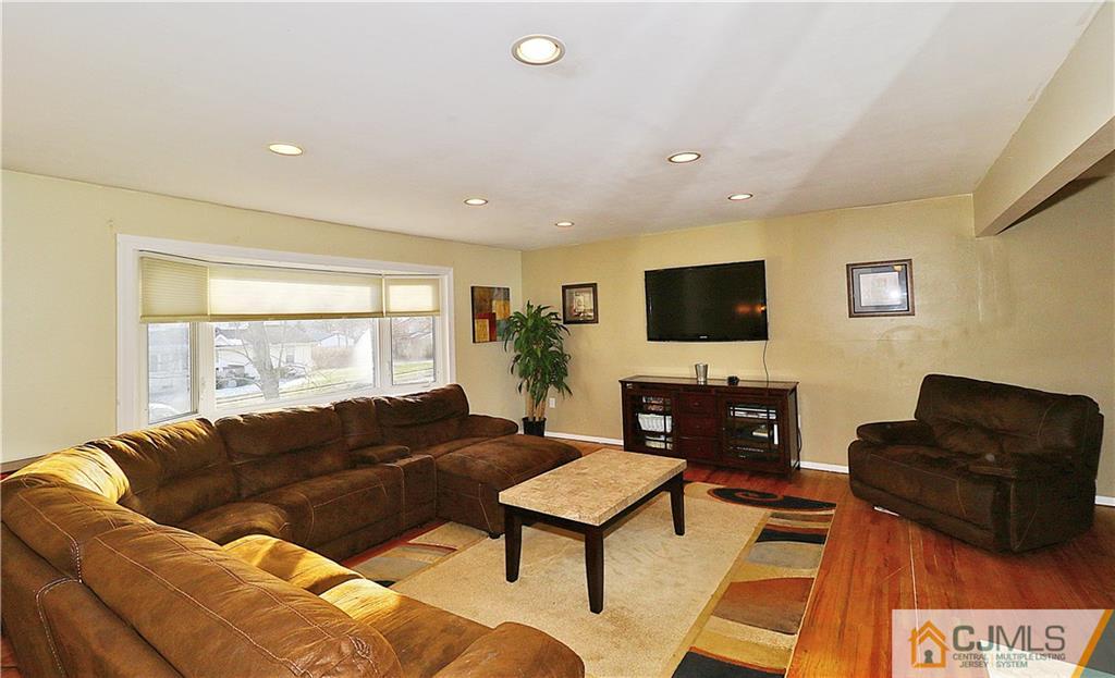 64 Valley Road Jackson, NJ 08527 - Photo 5 of 24 a living room with furniture a flat screen tv and a fireplace