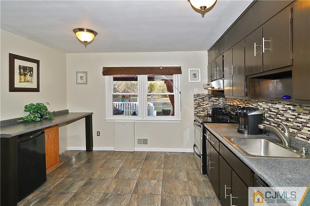 64 Valley Road Jackson, NJ 08527 - Photo 9 of 24 a kitchen with a sink stove and cabinets