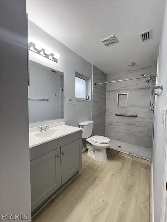 a view of bathroom with a toilet sink and mirror
