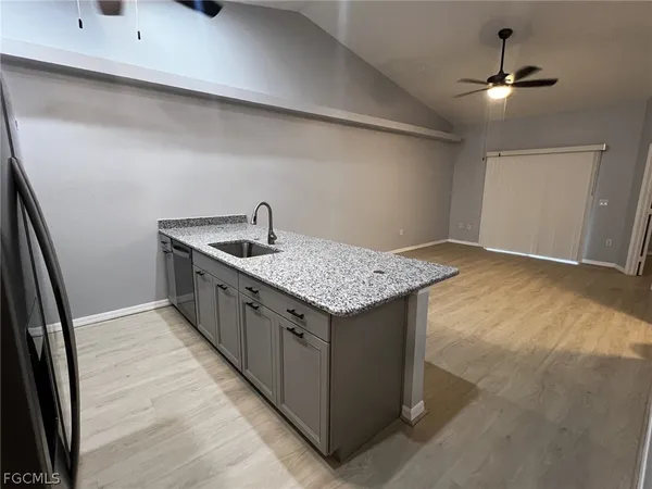 a kitchen with a stove a sink and a refrigerator