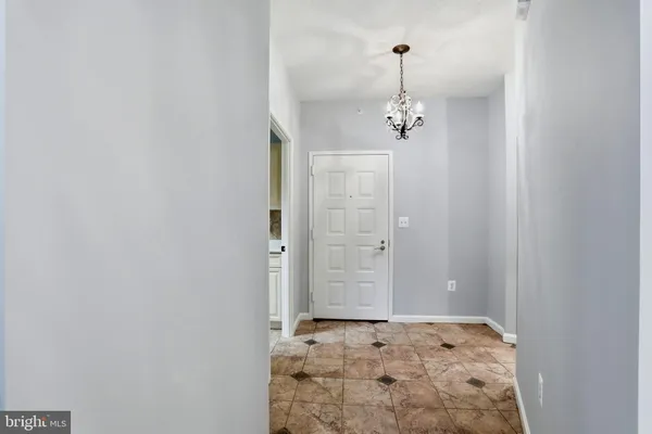a view of a hallway with closet and wooden floor