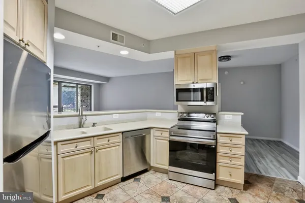 a kitchen with stainless steel appliances granite countertop a stove and a sink