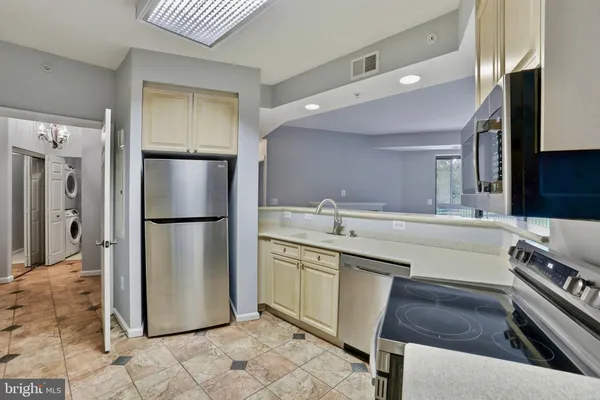 a kitchen with a sink appliances and a refrigerator