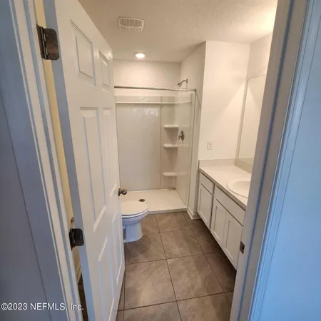 a bathroom with a tub shower and a sink