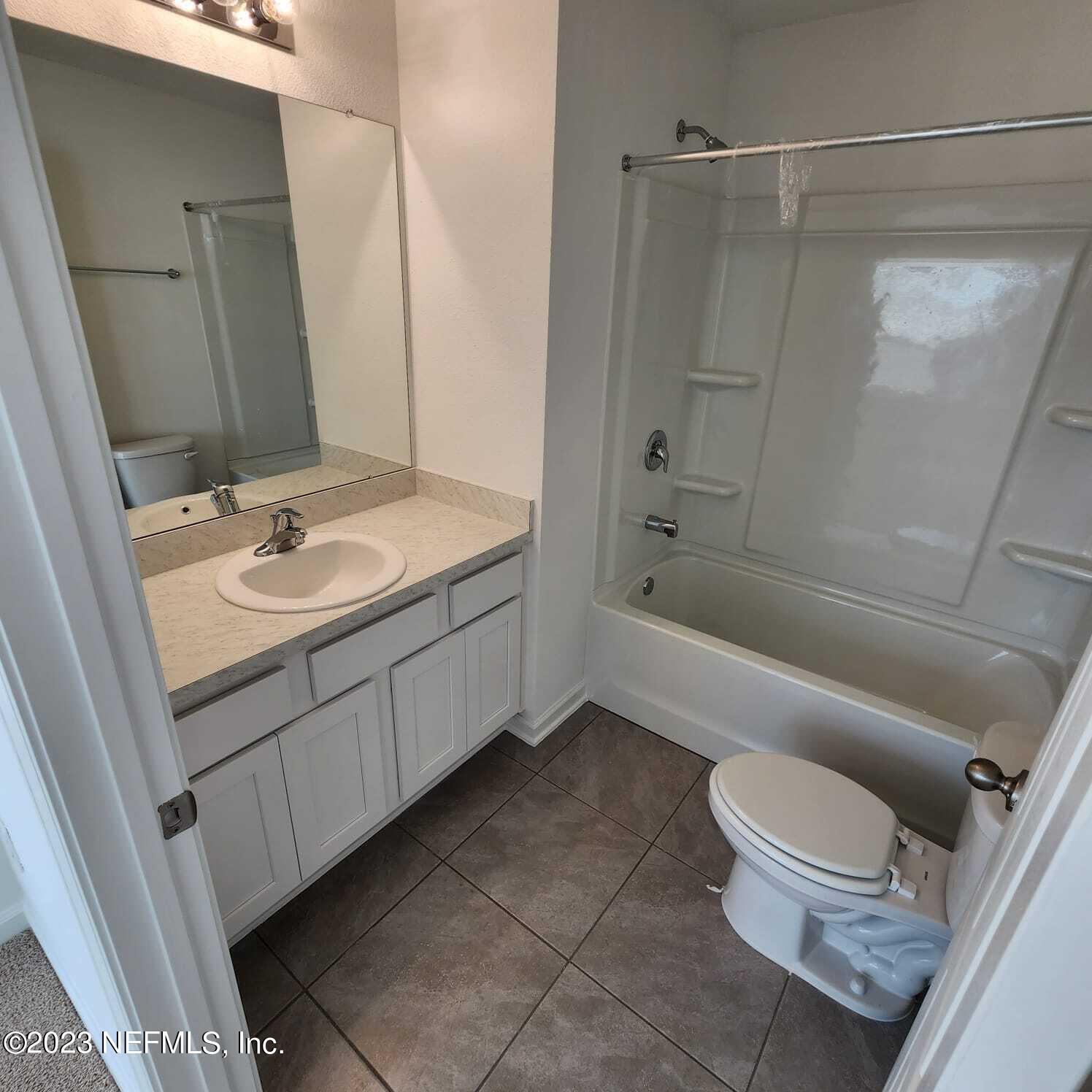 8409 Zenith Circle Jacksonville, FL 32256 - Photo 12 of 23 a bathroom with a granite countertop sink toilet and shower
