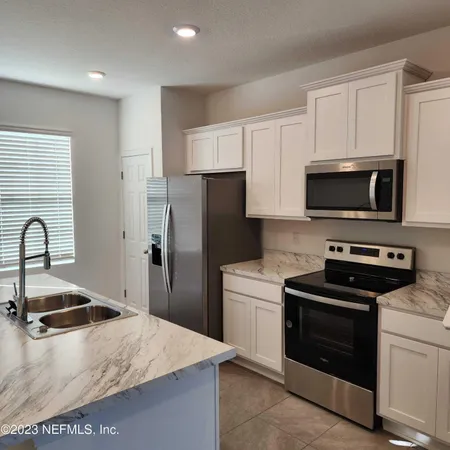 a kitchen with a sink stove and refrigerator