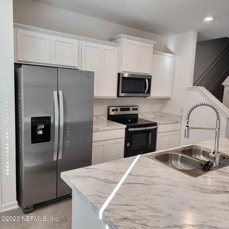 a kitchen with a refrigerator sink and microwave