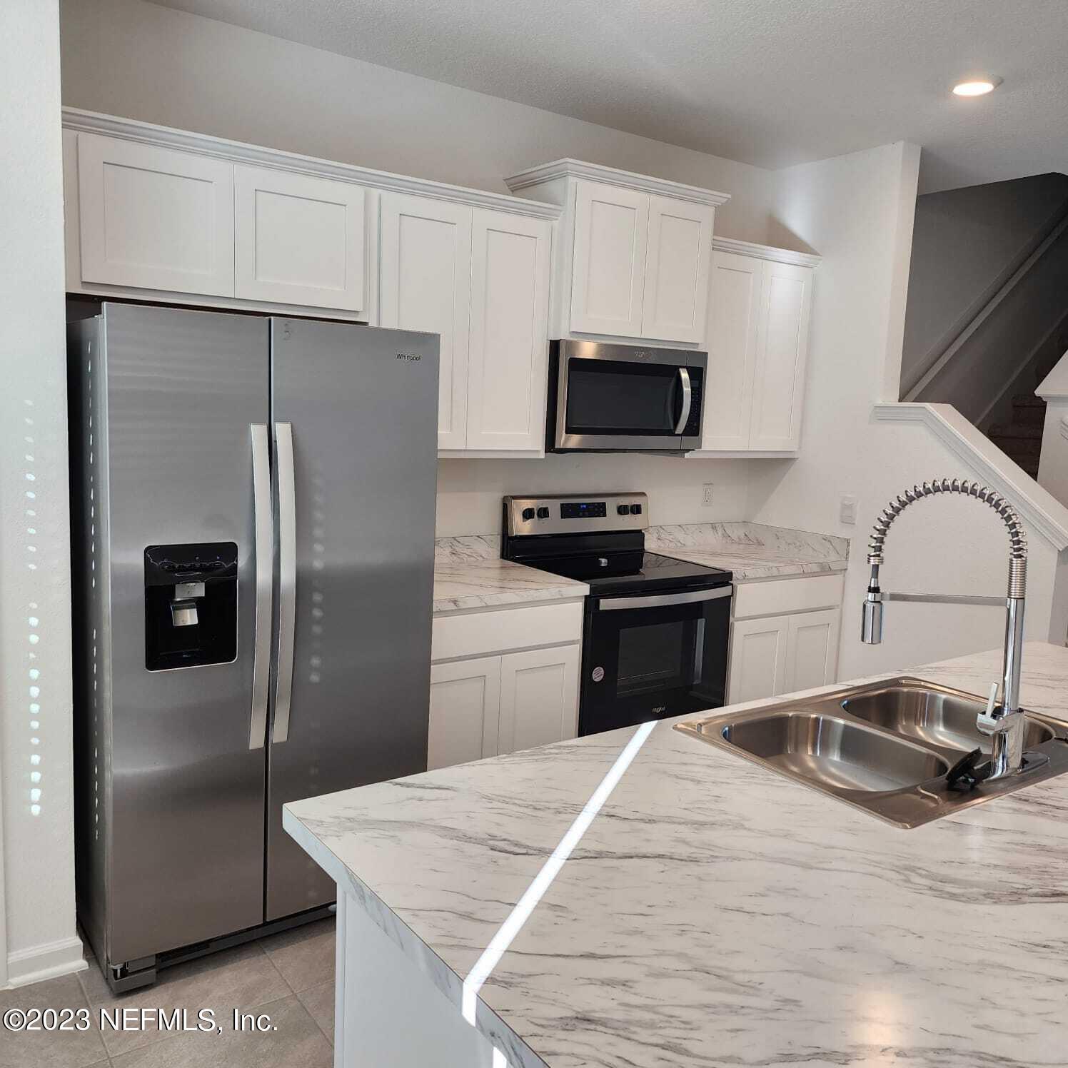 8409 Zenith Circle Jacksonville, FL 32256 - Photo 5 of 23 a kitchen with a refrigerator sink and microwave
