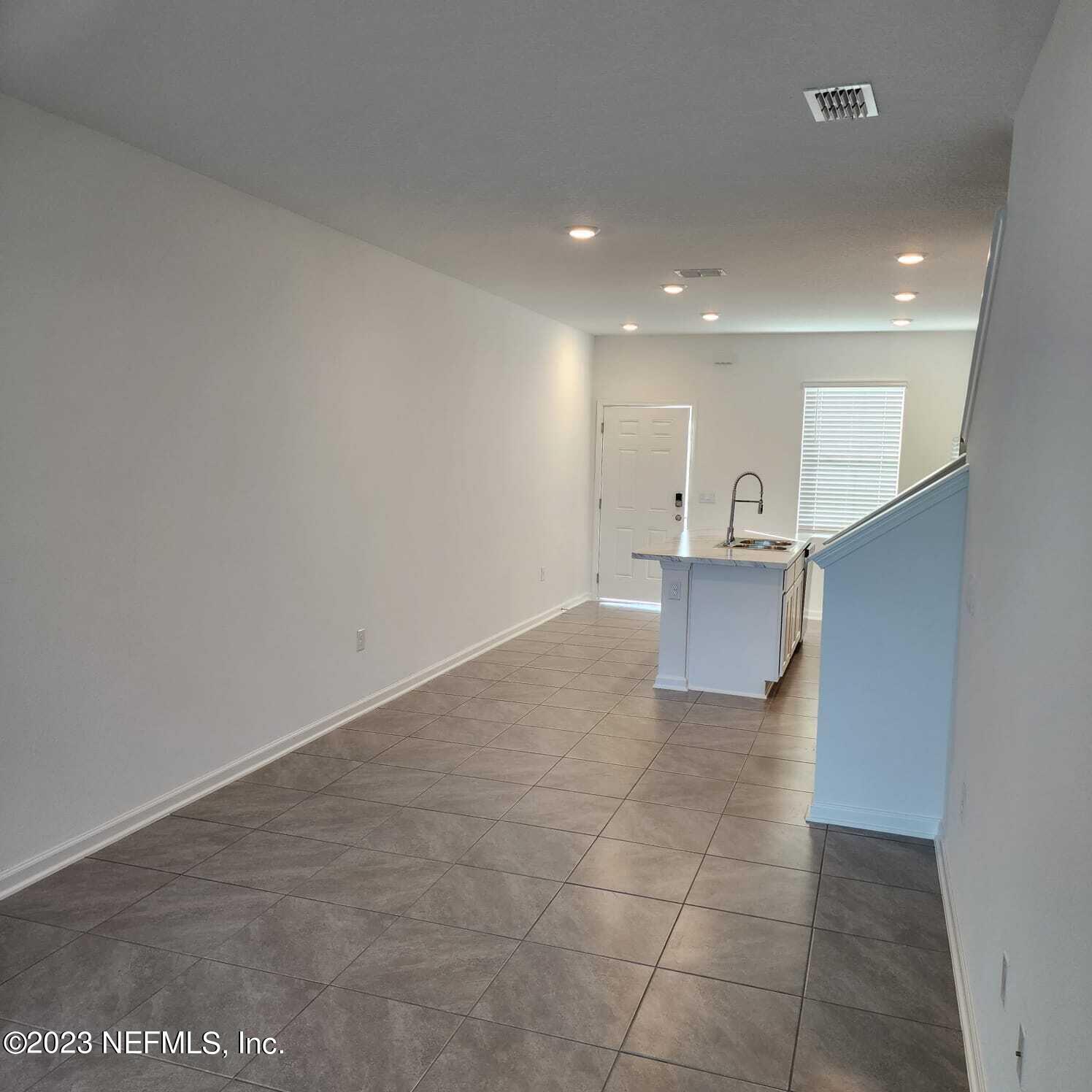 8409 Zenith Circle Jacksonville, FL 32256 - Photo 7 of 23 a view of a kitchen with a sink and a refrigerator