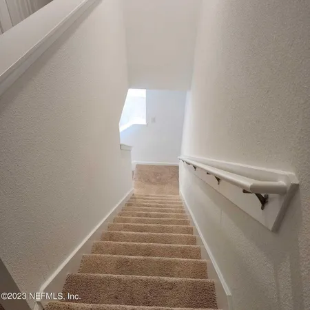 a view of a hallway with stairs