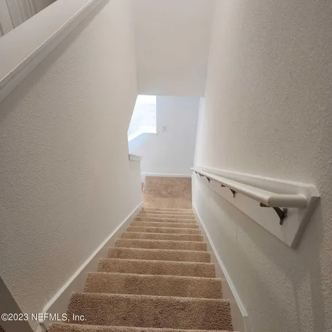 a view of a hallway with stairs