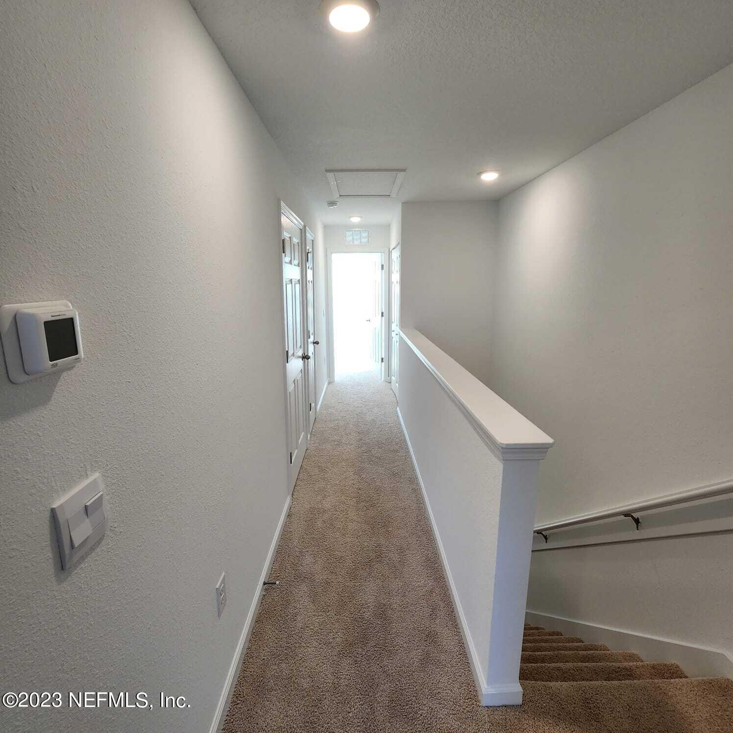 8409 Zenith Circle Jacksonville, FL 32256 - Photo 9 of 23 a view of a hallway with stairs