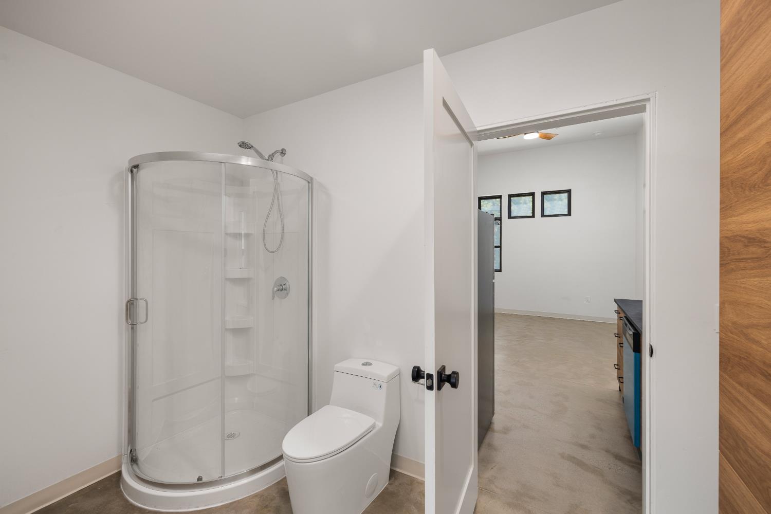 18093 Lasso Loop, Unit B Penn Valley, CA 95946 - Photo 22 of 26 a bathroom with a granite countertop toilet and a shower