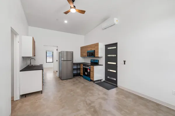 a kitchen with stainless steel appliances kitchen island a refrigerator sink and stove