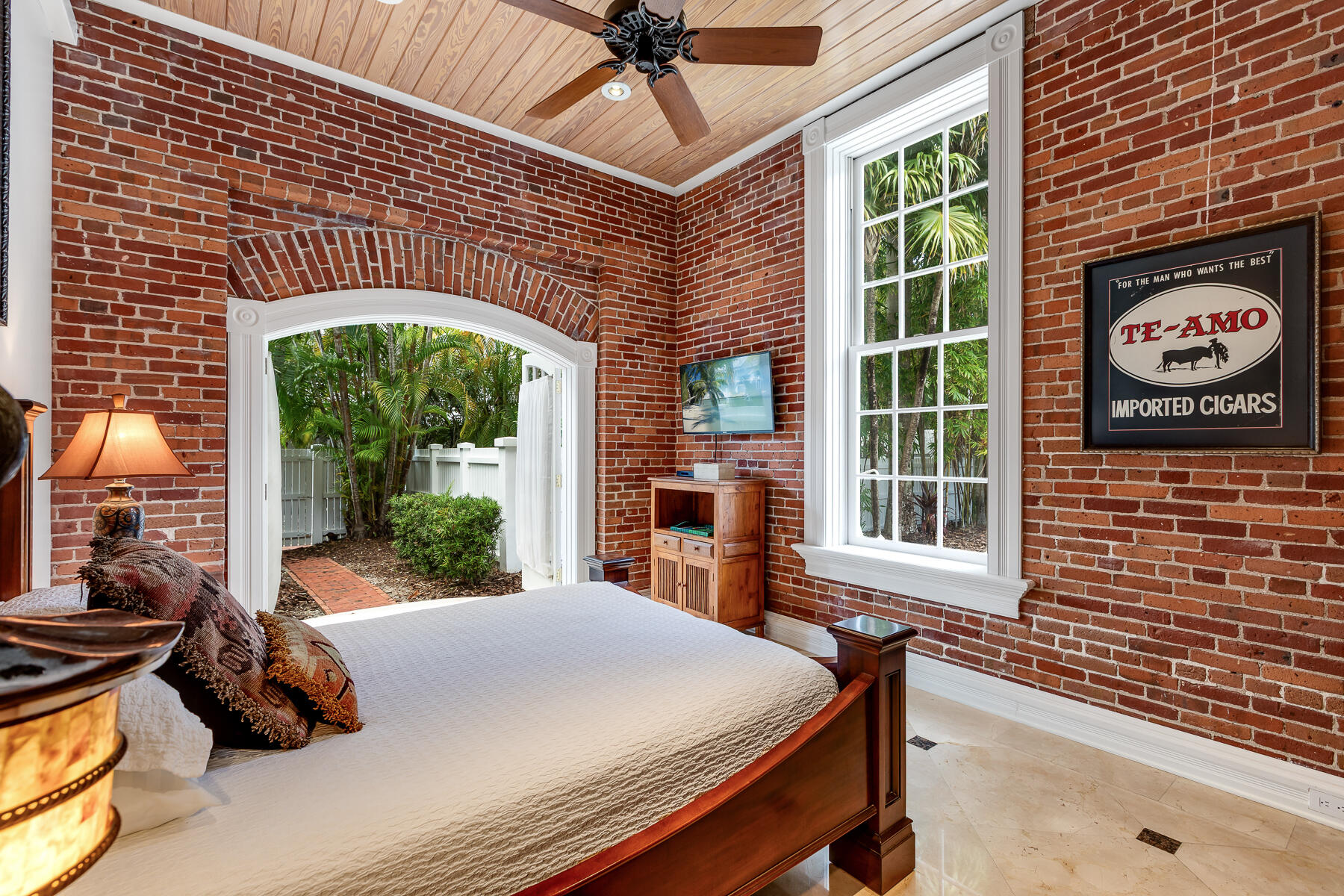 103 Front Street Key West, FL 33040 - Photo 32 of 44 a view of a patio with table and chairs potted plants with wooden floor