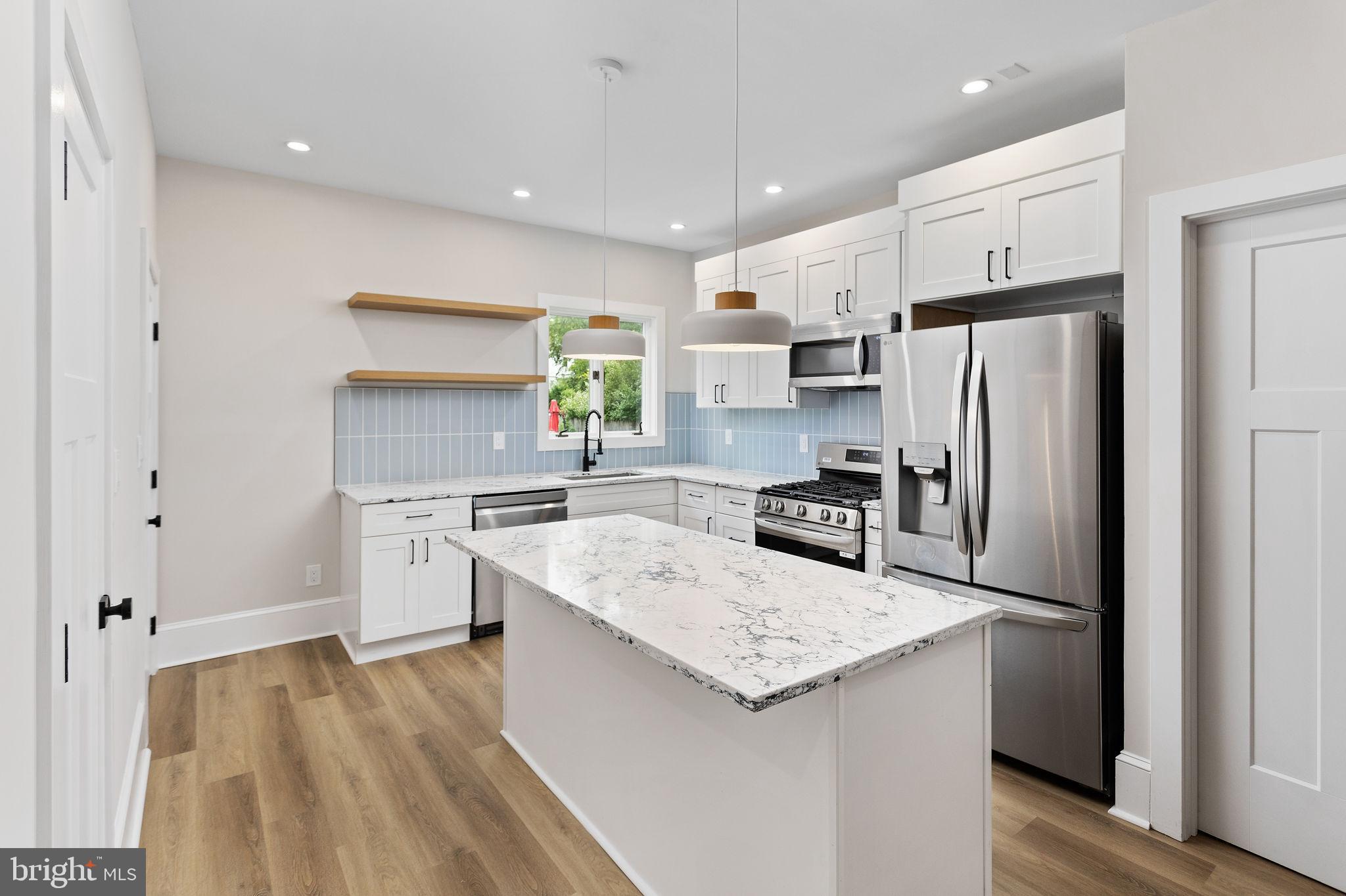 26 Jefferson Road Princeton, NJ 08540 - Photo 11 of 32 a kitchen with a refrigerator a sink and cabinets