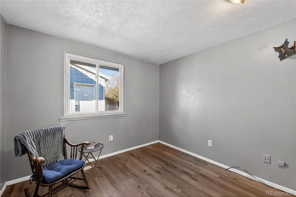 a room with a chair and wooden floor