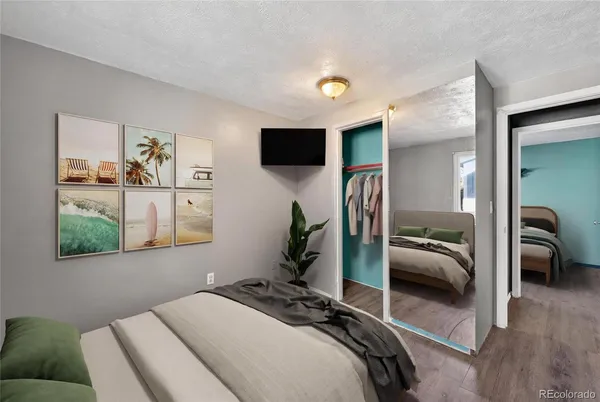 a bedroom with a bed next to a window