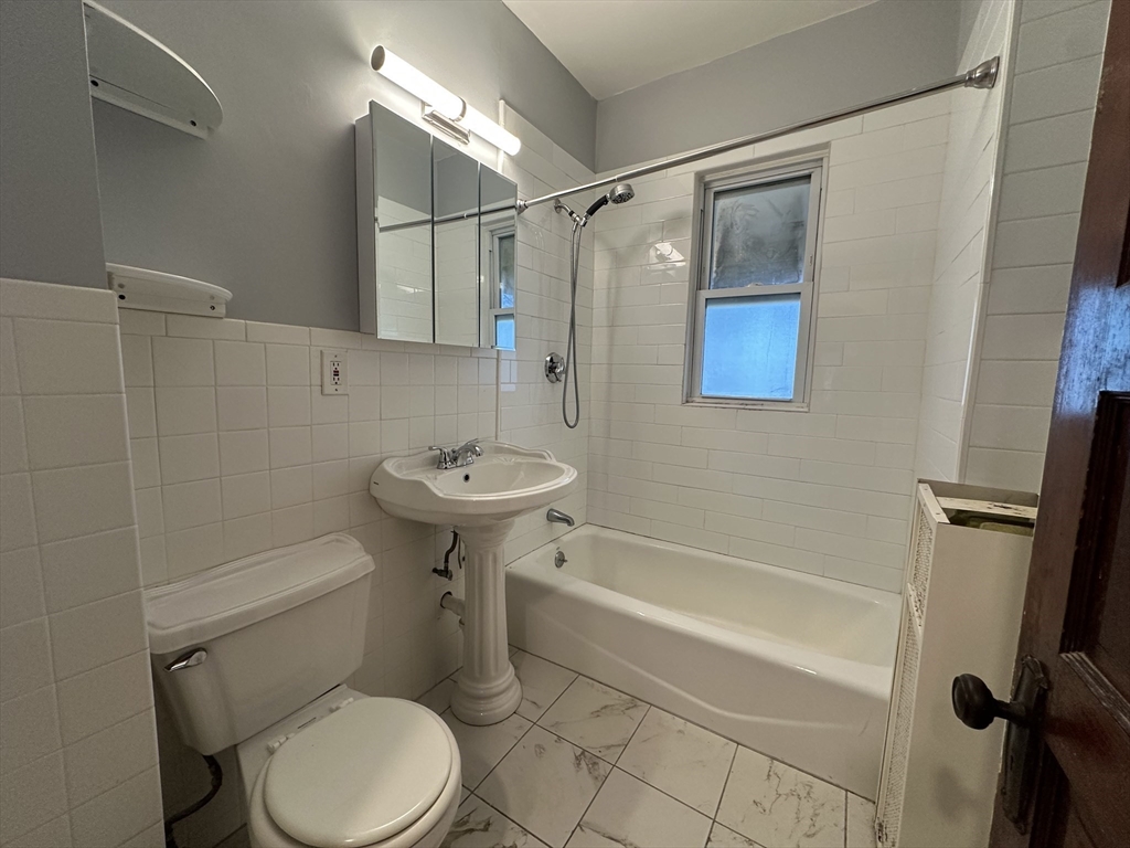 17 Manley Street, Unit 2 Boston, MA 02122 - Photo 13 of 16 a bathroom with a sink toilet and shower