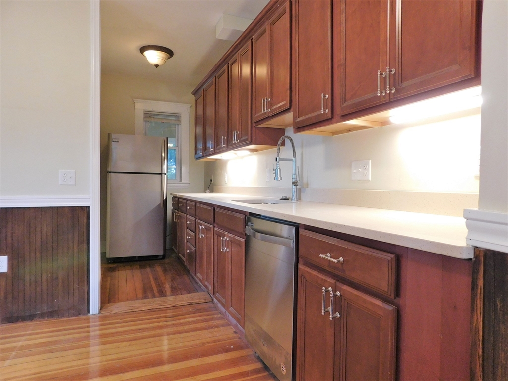 17 Manley Street, Unit 2 Boston, MA 02122 - Photo 7 of 16 a kitchen with a sink a refrigerator and cabinets