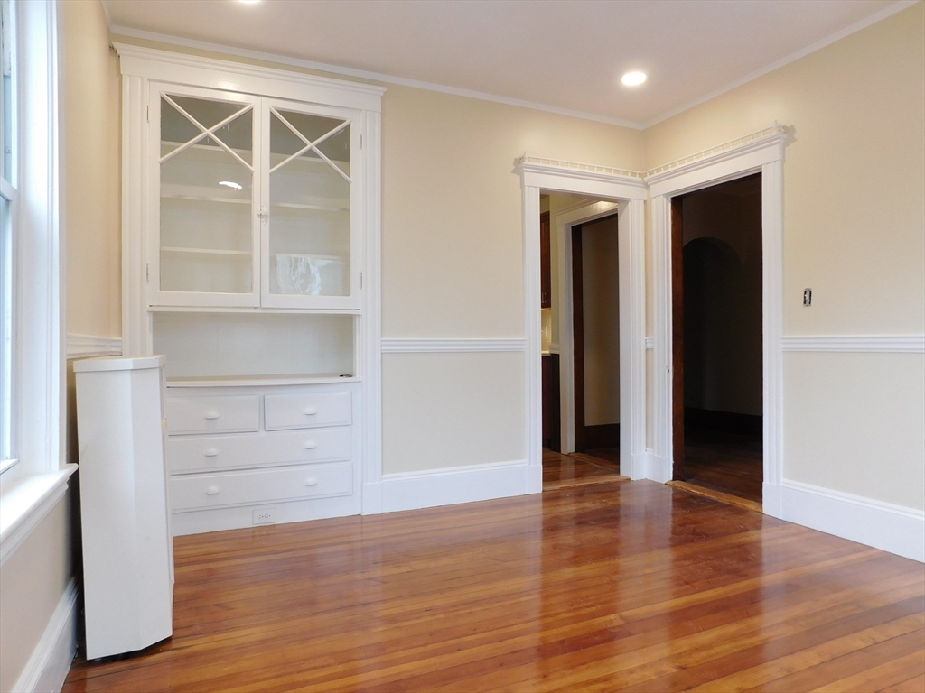 17 Manley Street, Unit 2 Boston, MA 02122 - Photo 8 of 16 an empty room with wooden floor and windows