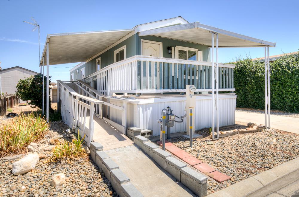 1218 East Cleveland Avenue, Unit 86 Madera, CA 93638 - Photo 13 of 14 a view of a house with a wooden deck