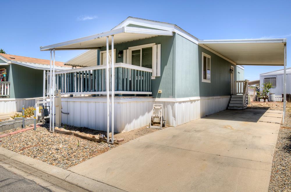 1218 East Cleveland Avenue, Unit 86 Madera, CA 93638 - Photo 3 of 14 a view of a house with a wooden fence