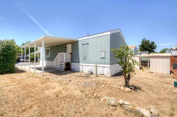 a view of a house with snow in front of it