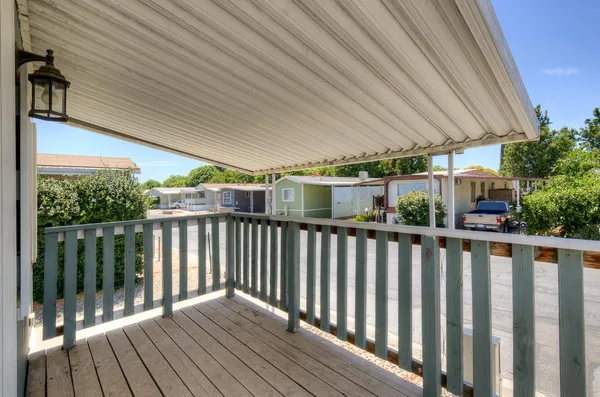 a view of a balcony with wooden floor