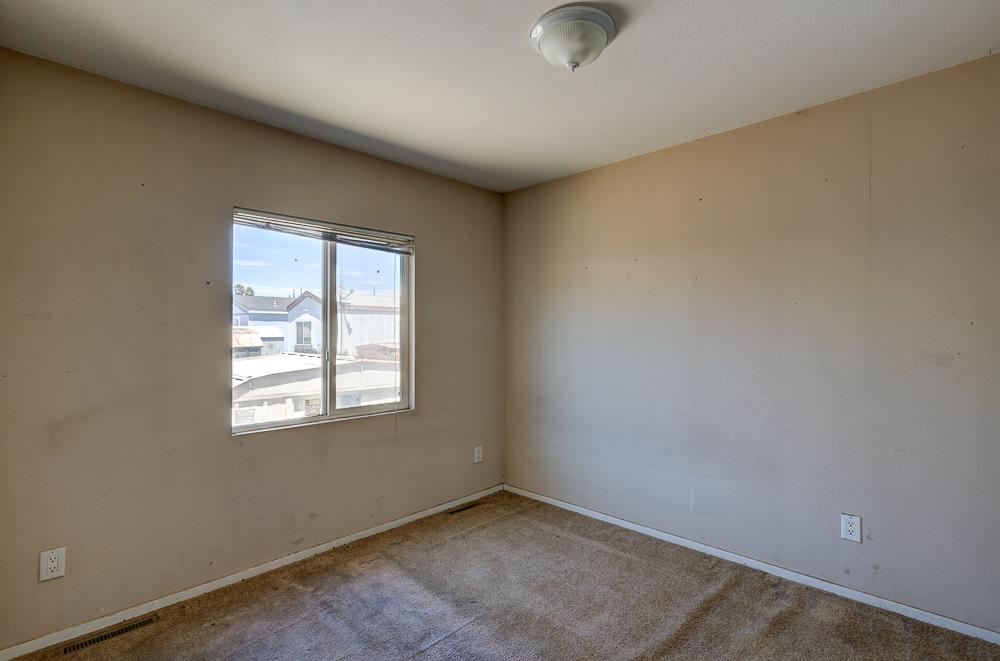 1218 East Cleveland Avenue, Unit 86 Madera, CA 93638 - Photo 9 of 14 an empty room with windows