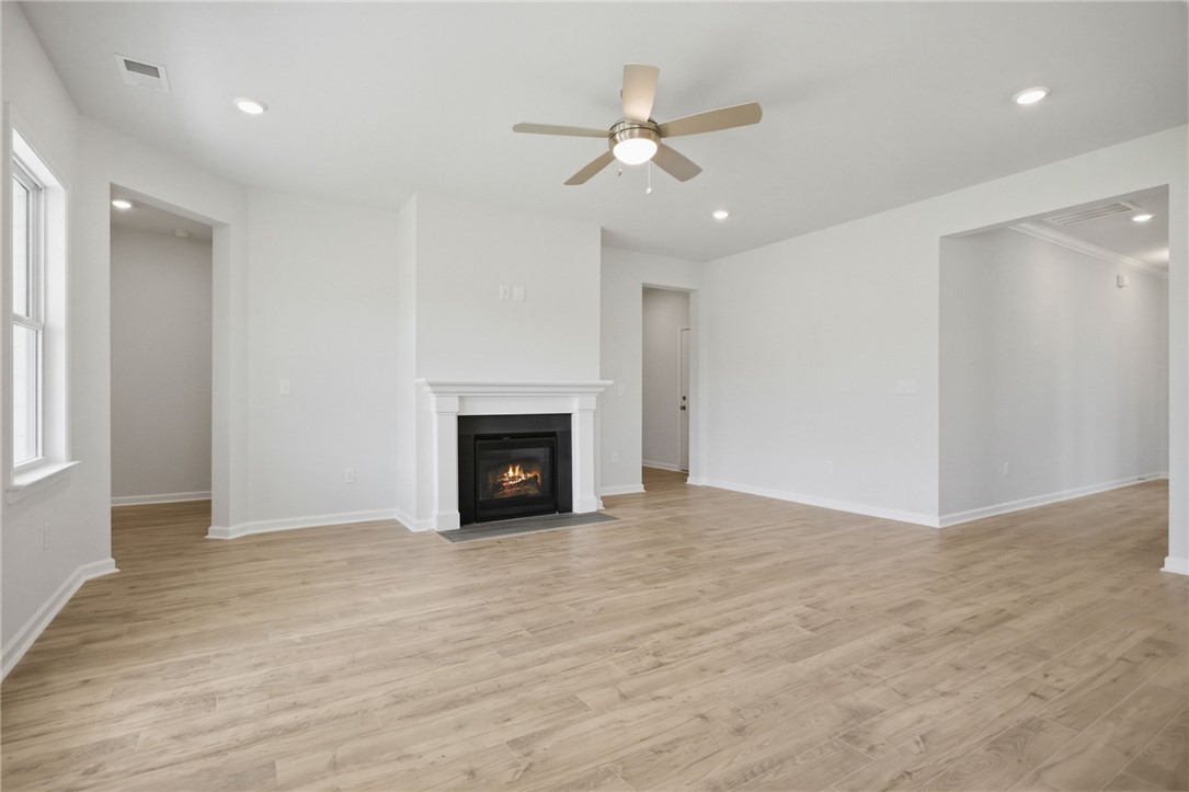 557 Hydrangea Street, Unit LOT 46 Seneca, SC 29678 - Photo 7 of 37 A comforting fireplace anchors this bright living space with abundant natural light.