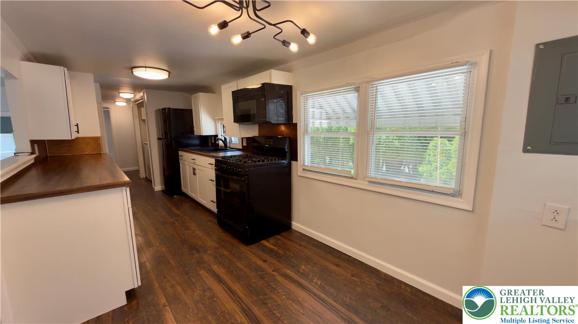 246 Poplar Street Bath, PA 18014 - Photo 15 of 34 A streamlined kitchen offering durable wood-look flooring and efficient appliances, perfect for daily routines.
