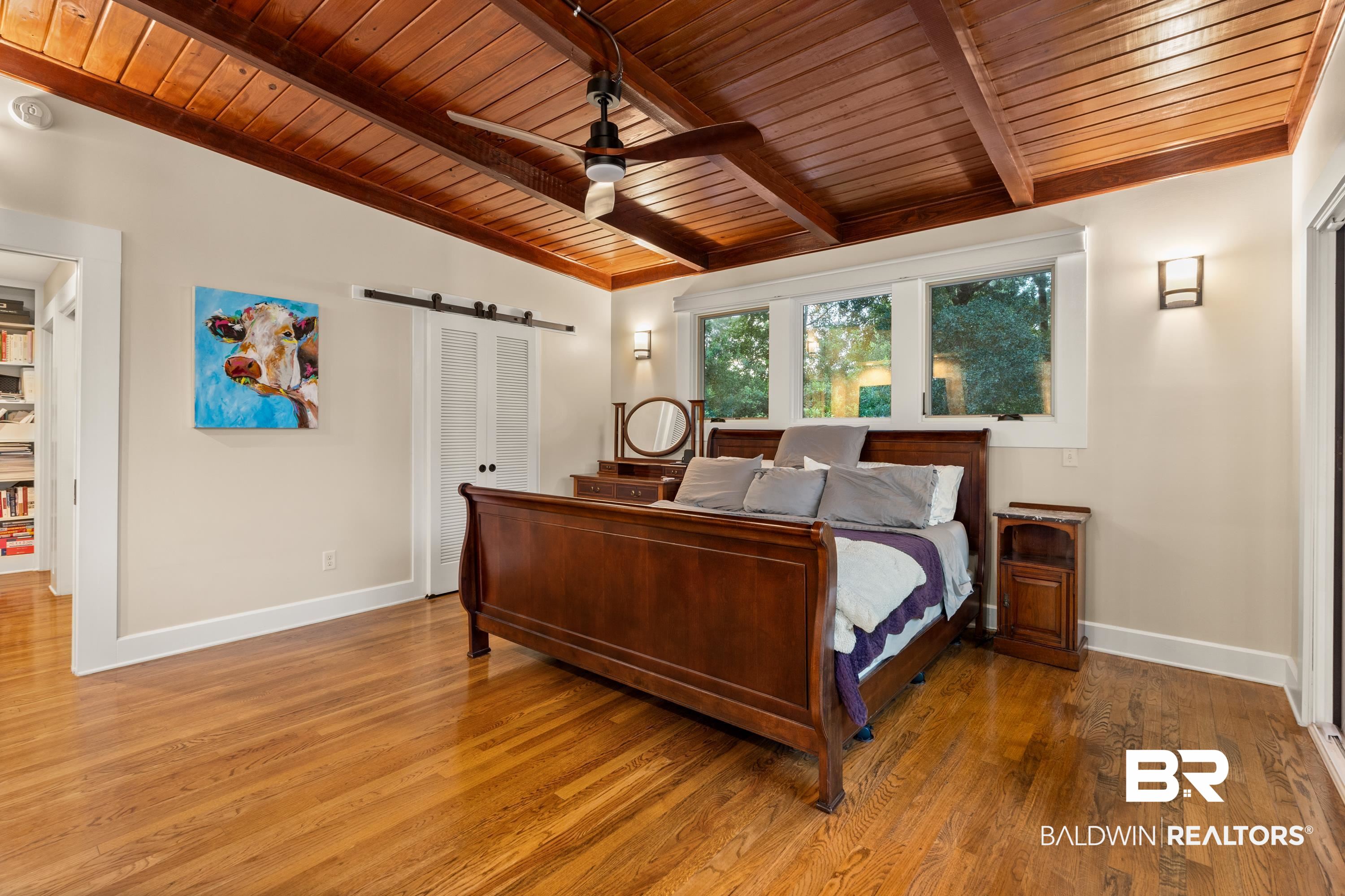 233 Suzanne Circle Mobile, AL 36608 - Photo 25 of 85 Bedroom with a barn door, a closet, wood ceiling, light wood-type flooring, and a ceiling fan