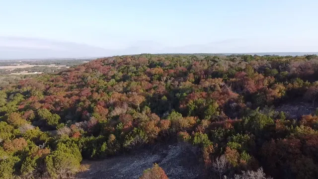 an aerial view of house with yard and mountain view in back
