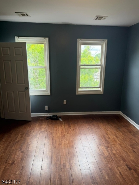 166 Renner Avenue, Unit 3 Newark, NJ 07112 - Photo 20 of 24 a view of an empty room with wooden floor and a window