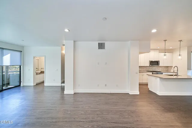 a view of a kitchen with a sink and a stove top oven