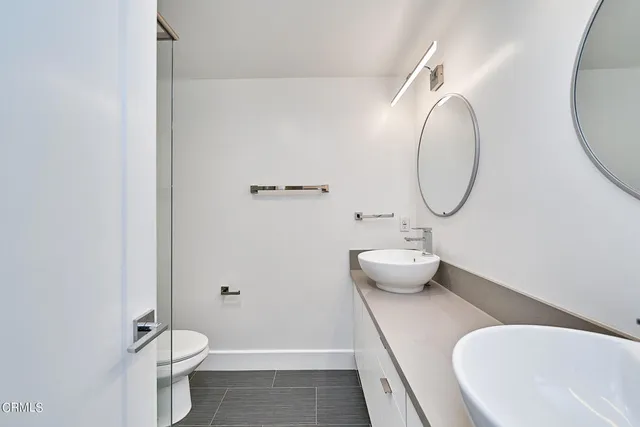 a bathroom with a toilet and a mirror