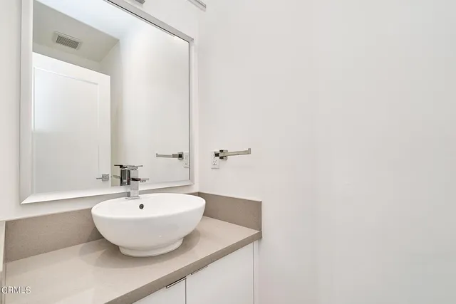 a view of a bathroom with a sink and mirror